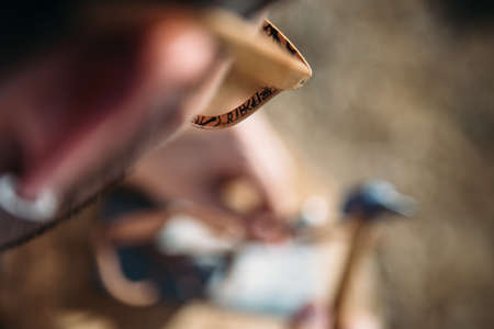 Overhead view of sunglasses on bearded brunet man working with hammerの写真素材