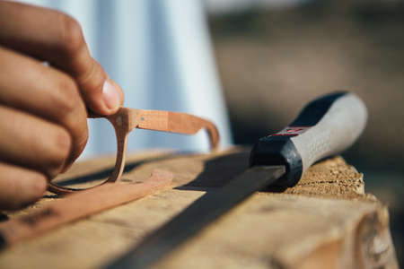 Close up of wooden blank of sunglasses and file on wooden workplaceの写真素材