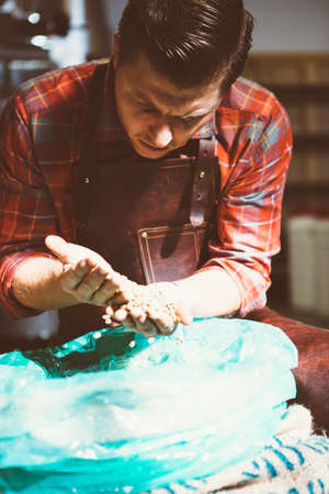 Portrait of brunet worker with coffee beans in sunlightの写真素材