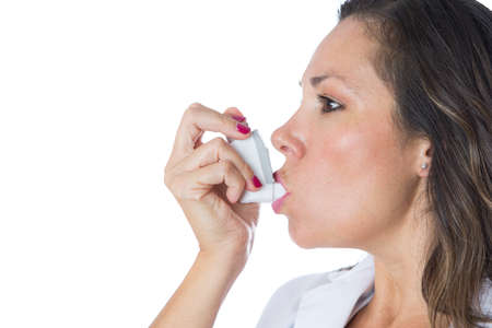 Female doctor is using a pressurized cartridge inhaler on a medical demostration - Isolated on a...