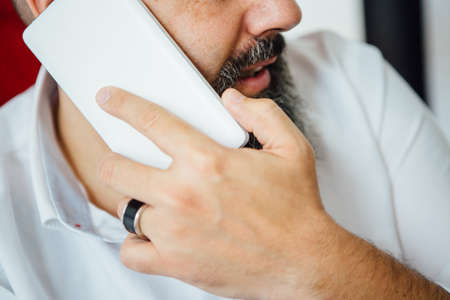 Bearded unrecognizable man talking on cell