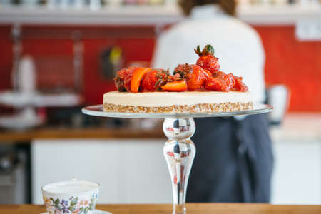 Close up of tasty cake with strawberry. Confectioner on backgroundの写真素材