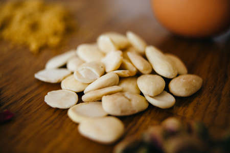 Pile of peeled almond on wooden tableの写真素材