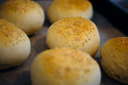 Close-up of sesame buns on oven-trayの写真素材