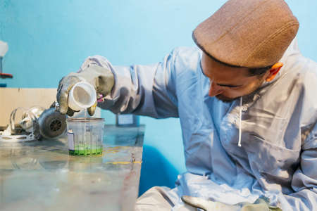 Bearded man pouring water in green colorの写真素材