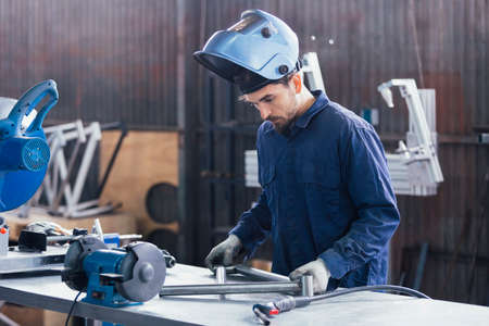 Bearded man in mask looking at bikes iron detail