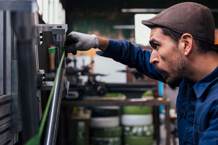 Bearded craftsman taking measurementsの写真素材