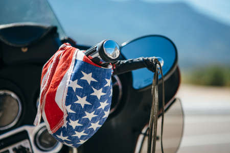 Colorful bandanna hanging on handlebar of bike in sunny day.の写真素材