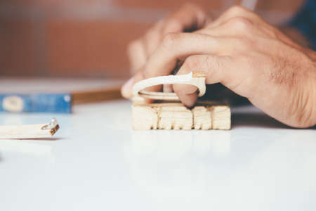 Crop shot of male hands working with glasses at workshop.の写真素材