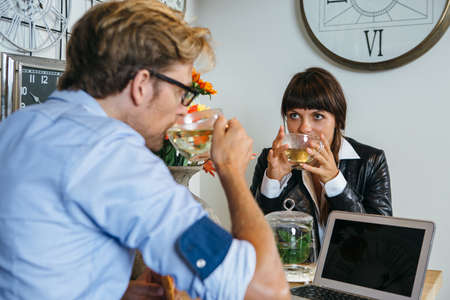 Man and woman sitting and drinking tea during the meeting in cafe.の写真素材