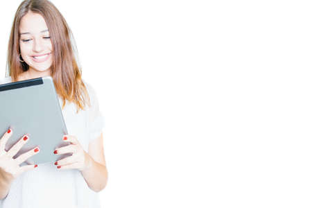 Young girl watching tablet and laughing happily isolated on white background. 