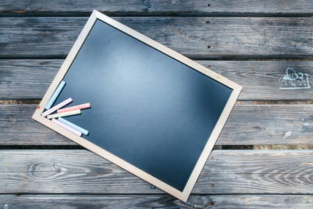 From above clear blackboard with chalk sticks placed on table.の写真素材