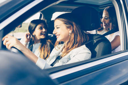 Group of girls friends traveling by carの写真素材