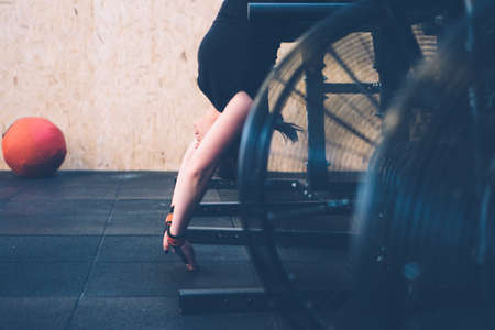 Young athlete woman doing ghd - gluteus ham developer - upside down on a cross-fit workout at the box gymの写真素材