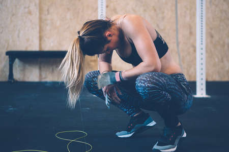 Exhausted young athlete woman after a jumping rope routine on a fitness routine at the box gymの写真素材