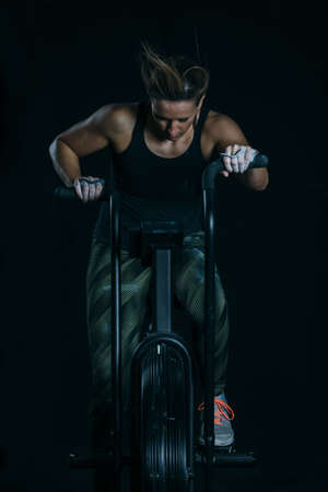 Close up of a young sporty woman doing calorie assault exercise on a fitness routine at the box gymの写真素材