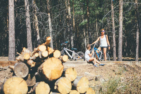 Young sporty woman and child with bicycle in the mountainの写真素材