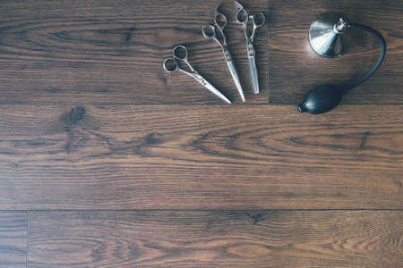 Top view of vintage barbershop tools and accessories on a wooden background. Copy space area...