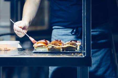 Cropped view of the hands of a chef preparing the spanish tapas in a professional kitchen