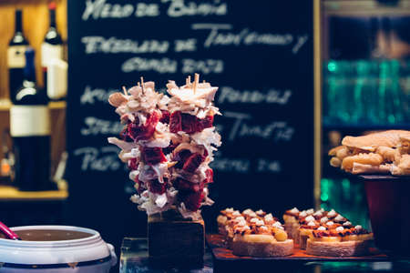 Close up view of tasty spanish ham tapas on a bar counter ready to be servedの写真素材