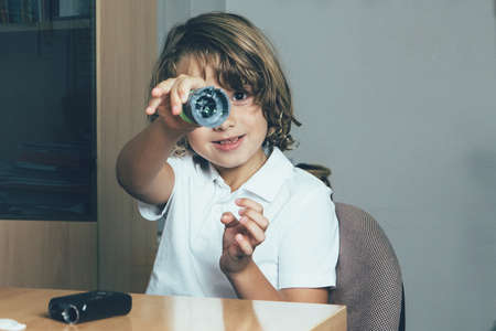 Smiling young diabetic patient is holding an insertion system of the infusion set in the doctor...