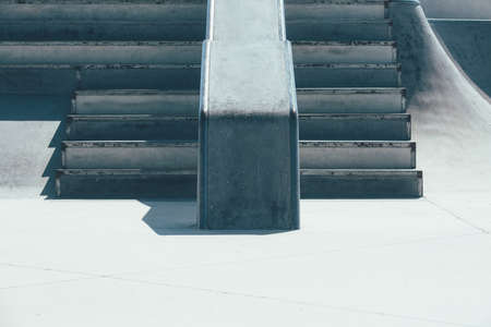 View of the detail of a ramp and the stairs used as obstacles of an empty urban skate park. Useful...