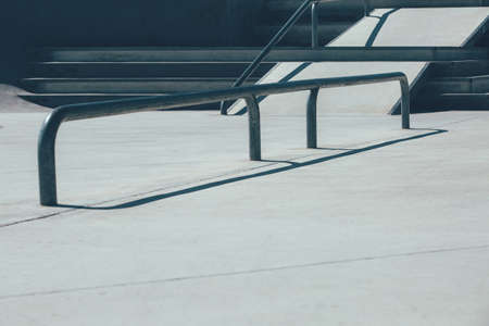 View of the stairs and the railings used as obstacles to make tricks in an empty urban skate park. Useful as a background.の写真素材