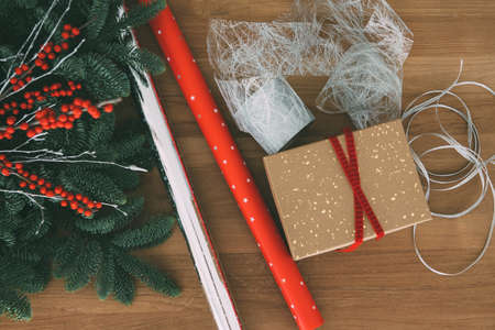 Top view of Christmas gift wrapping tools composed of wrapping paper, box and ribbons useful as a...