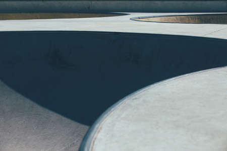 Detail of the ramps used as obstacles to make tricks in an empty urban skate park. Useful as a...