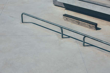 View of the obstacles to make tricks in an empty urban skate park as railings, stairs. Useful as a...