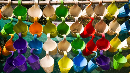 Colorful plastic spoons in a row on a bamboo stand.