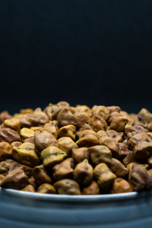Chickpeas in a bowl on a black background. Selective focus.の写真素材
