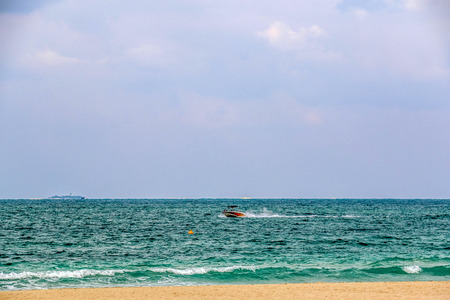 Horizon of Seascape, water waves at Jumeirah Beach under cloudy sky in Dubai, United Arab Emiratesの写真素材
