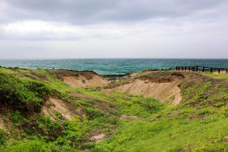 Lush green landscape and Marneef Cave at Al Mughsayl Beach Mountains, Salalah, Omanの写真素材