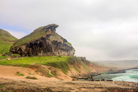 Lush green landscape and Marneef Cave at Al Mughsayl Beach Mountains, Salalah, Omanの写真素材