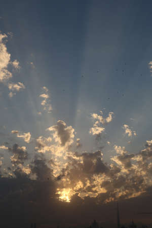 Scenic sunset and natural dramatic cloudy sky and sunbeam view over Dubai, United Arab Emiratesの写真素材