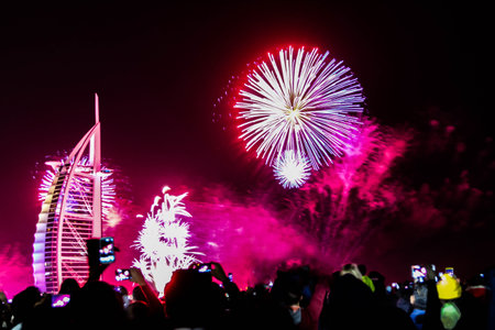 Dubai, UAE - 01/01/2019 - Explosion of multi-colored fireworks at Burj Al Arab Jumeirah Dubai against the night sky on a new year celebrations holidays in Dubai, UAEのeditorial素材