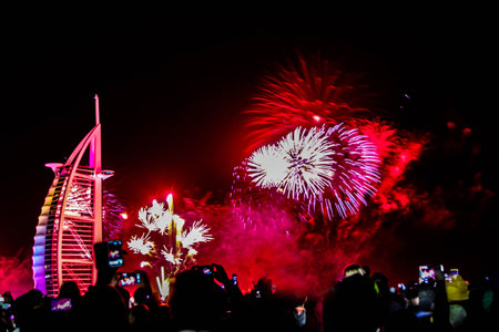 Dubai, UAE - 01/01/2019 - Explosion of multi-colored fireworks at Burj Al Arab Jumeirah Dubai against the night sky on a new year celebrations holidays in Dubai, UAEのeditorial素材