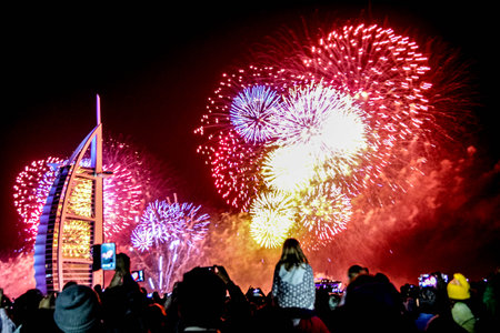 Dubai, UAE - 01/01/2019 - Explosion of multi-colored fireworks at Burj Al Arab Jumeirah Dubai against the night sky on a new year celebrations holidays in Dubai, UAEのeditorial素材