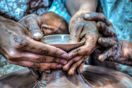 Woman's hands working on a piece of potteryの写真素材