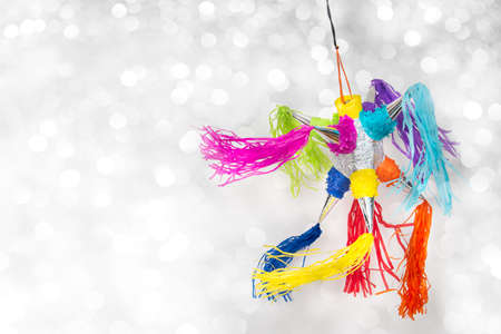 Mexican pinata party hanging background with bright multicolored celebrating birthday, Christmas,...