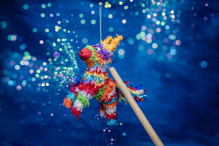 mexican piÃ±ata party hanging on blue and green background with multi-colored glitters celebrating birthday, christmas, party, party songs, figure in the shape of star and donkey, family funの写真素材