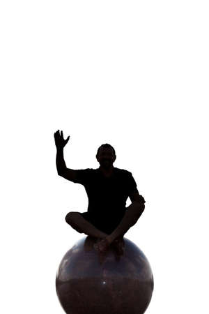 with the silhouette of a man sitting on a ballの写真素材