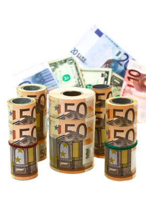 different denominations of banknotes in rolls and in bulk on a white backgroundの写真素材