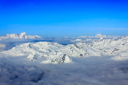 Visibility for miles around with a view from the top of the Aiguille Rouge high in the alps  A mysterous clloud covering lower down の写真素材