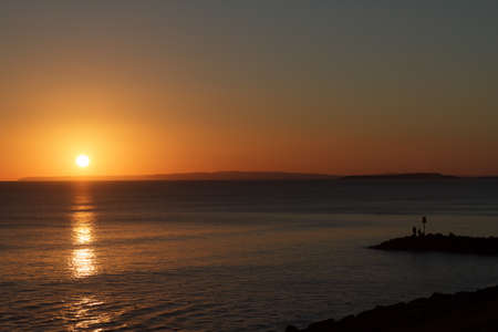 A Lone Fisherman casts a rod out into the English Channel at Milford on Sea の写真素材
