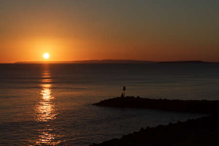 A Lone Fisherman casts a rod out into the English Channel at Milford on Sea の写真素材