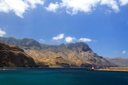 Looking down the west side of the island of Gran Canaria from the port of Agaete  A Single costal road leads up through the Cliffs and Mountains - its not for the faint hearted の写真素材