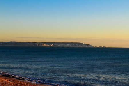 The Needles and the famous lighthouse from across the solent at dusk の写真素材
