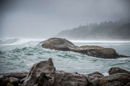 Swell coming over rocks in cove at the Oregon Coast.の写真素材